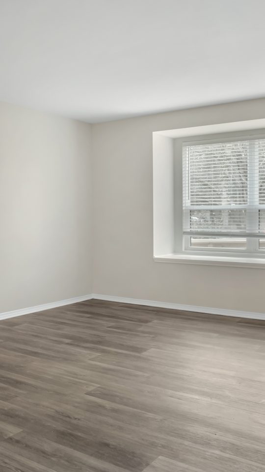 an empty room with hardwood floors and a window at The  Marley